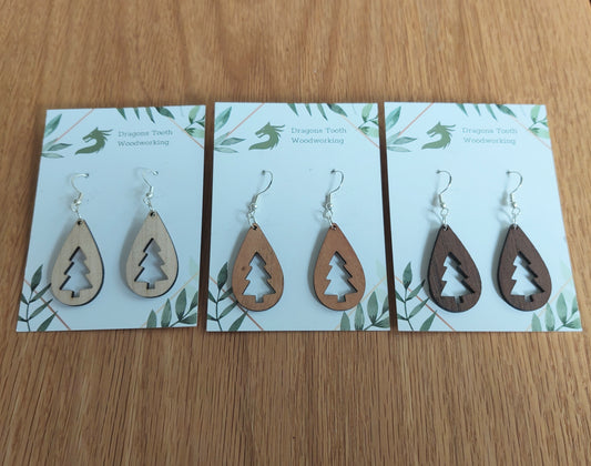 An alternate view displaying the Christmas tree teardrop earrings in three available wood types: light Maple, warm Cherry, and deep Walnut.