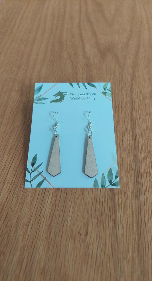 A front view of the minimalist tie silhouette earrings crafted from light, bright blonde solid Maple wood, displayed on an earring card.