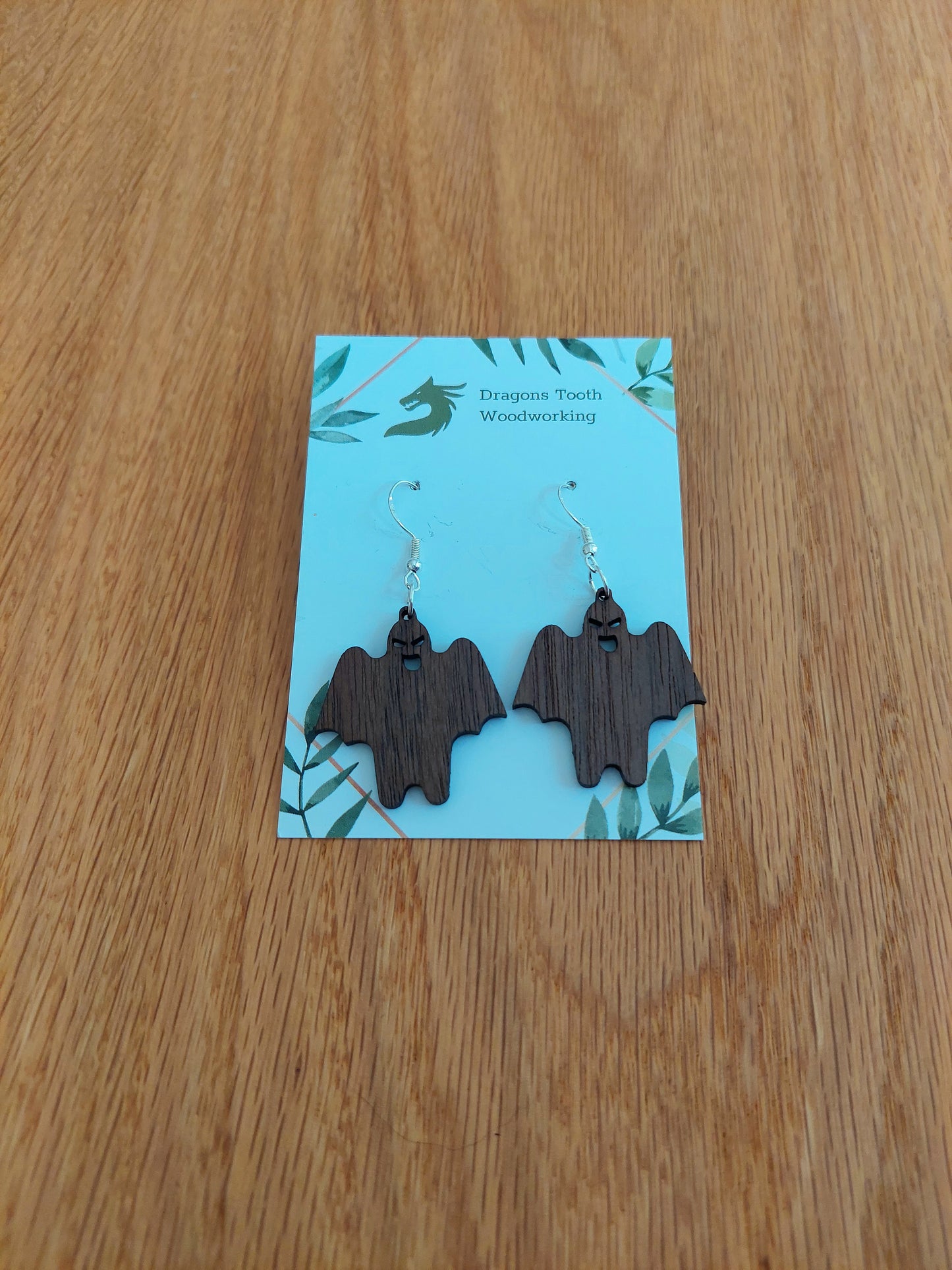 Deep chocolate brown walnut wood ghost ghoul dangle earrings, unique handcrafted spooky gothic jewelry.