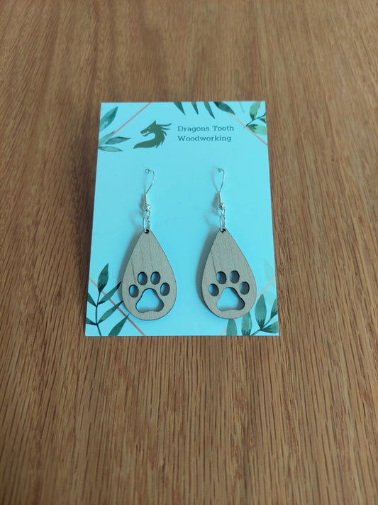 Light blonde natural maple wood pawprint dangle earrings, minimalist nature-inspired jewelry for dog and cat owners.