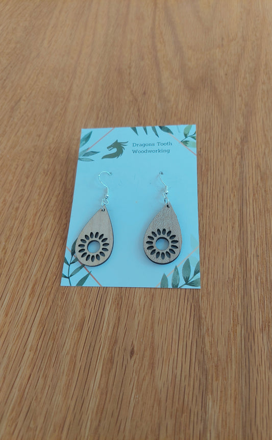 Bright blonde natural maple wood sunflower earrings featuring an intricate geometric laser-cut floral design.