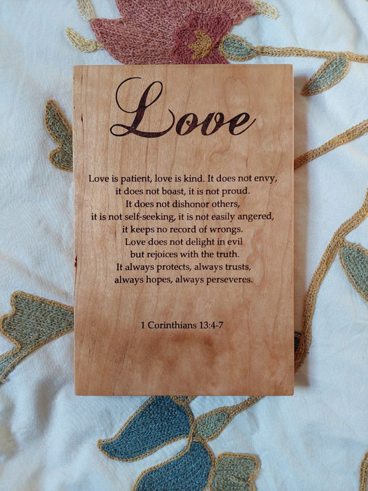 Straight-on view of an 8x12 Cherry wood plaque engraved with 1 Corinthians 13 scripture passage.