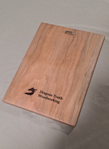 The back of a solid wood plaque showing the clean, smooth wood finish and a pre-installed, heavy-duty sawtooth hanger for wall mounting.