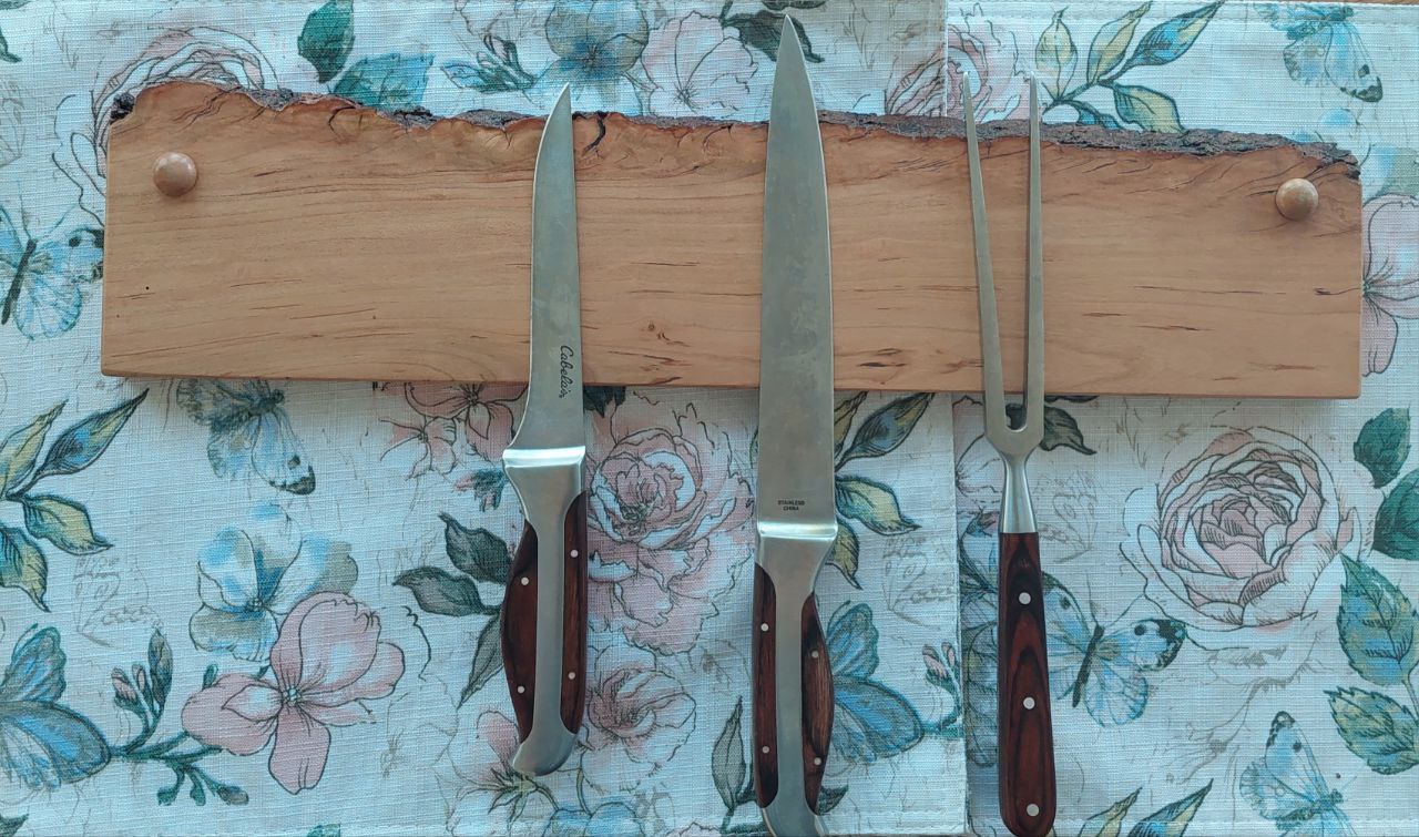 A front on view of a cherry knife block with hidden magnets to hold kitchen knives. The knife block features a live edge.
