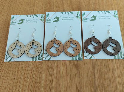 An alternate view displaying the Christmas stocking earrings in three available wood types: light Maple, warm Cherry, and deep Walnut.