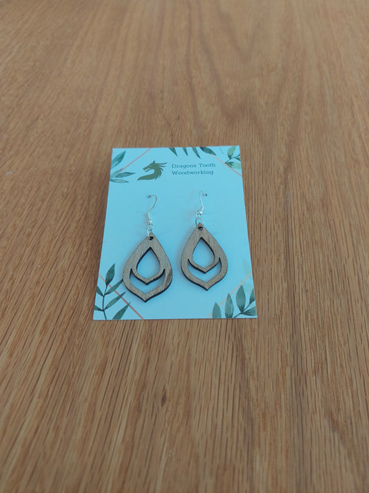 A front view of the budding flower bulb earrings crafted from light, bright blonde solid Maple wood, displayed on an earring card.