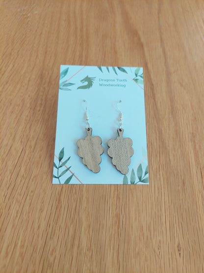 A front view of the grape cluster earrings crafted from light, bright blonde solid Maple wood, displayed on an earring card.