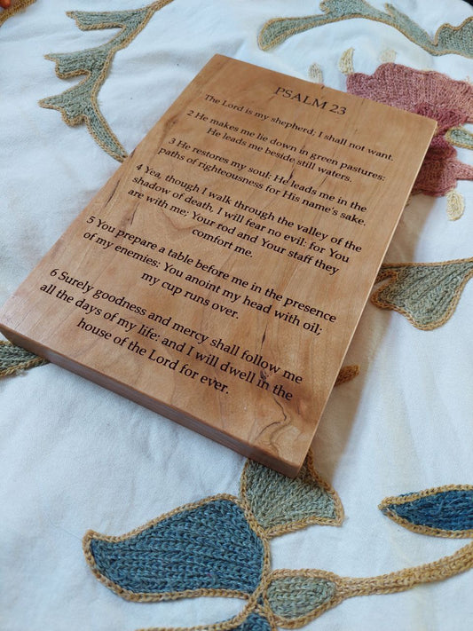 Close-up angled view showing the precision CNC engraving details on a solid wood Psalm 23 plaque.