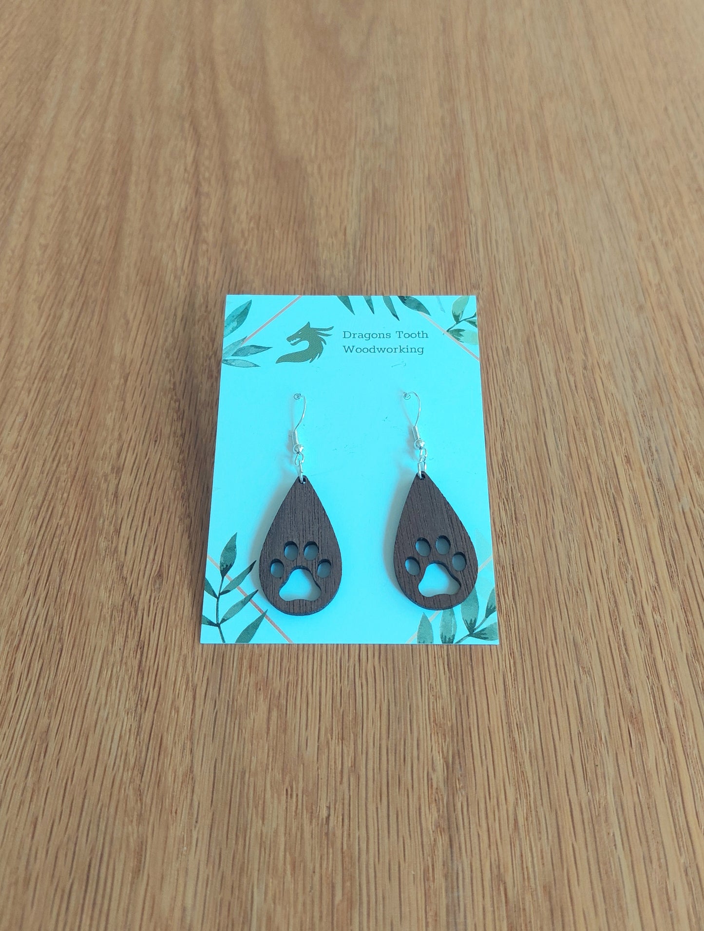 Deep chocolate brown walnut wood pawprint earrings, handcrafted natural hardwood jewelry for pet lovers.