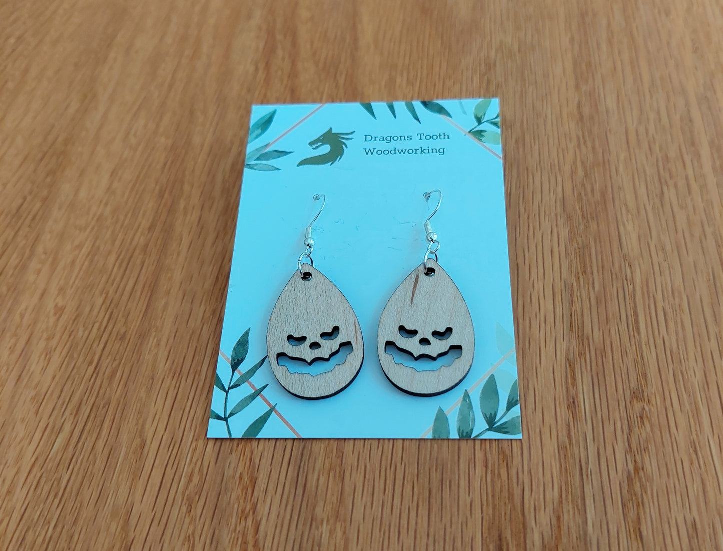 Light blonde natural maple wood jack-o-lantern earrings, a clean and minimalist pumpkin silhouette accessory handcrafted in Virginia.