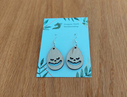 Light blonde natural maple wood jack-o-lantern earrings, a clean and minimalist pumpkin silhouette accessory handcrafted in Virginia.
