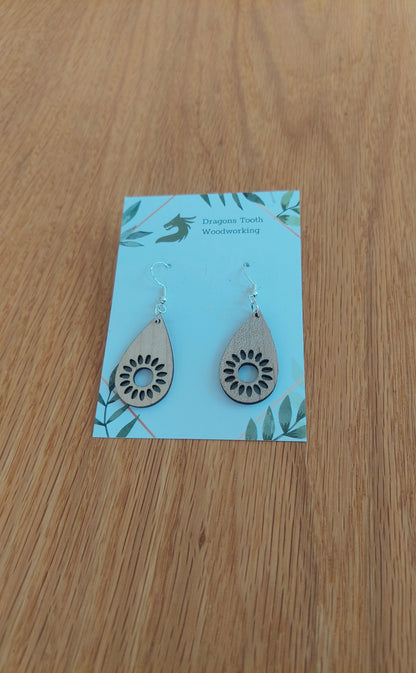 Bright blonde natural maple wood sunflower earrings featuring an intricate geometric laser-cut floral design.